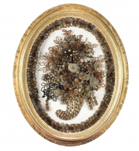 An ornate Victorian Hairwork wreath in an ornate frame